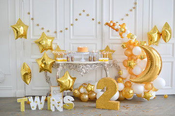 Decorations for birthday party in gold style. A lot of balloons gold colors. twins party.  