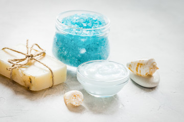 Obraz na płótnie Canvas blue spa composition with blue sea salt and natural soap on ston