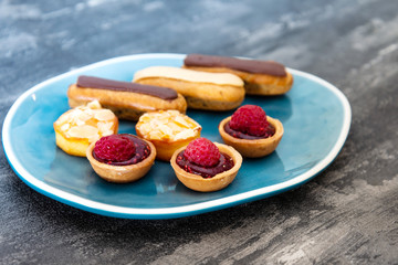 Mixed dessert Raspberry tartlet, Eclair Puffs, almond lemon