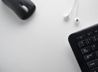 Abstract Mouse and keyboard with headphone on a white backdrop.