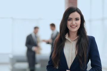 Portrait of businesspeople working with female leader in front.