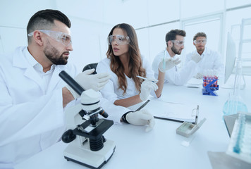 Fototapeta premium group of young scientists discussing the results of a study