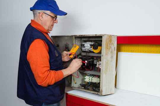 electrician fixing  electrical system with different tools