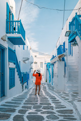 young woman on vacation at the Greek island Mykonos or Mikonos Greece - obrazy, fototapety, plakaty