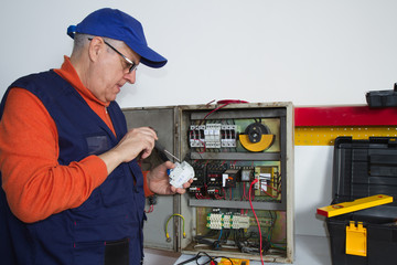 electrician fixing  electrical system with different tools