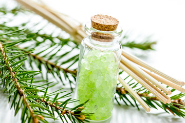 Spruce spa with organic salt in bottles on white table backgroun