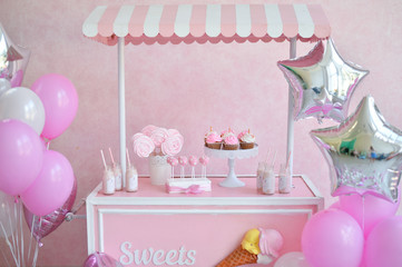 Decorations for birthday party. a lot of balloons pink and silver colors. Cakes for holiday party. 