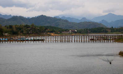 Fototapeta na wymiar View of The old wooden bridge Bridge collapse Bridge across the river (Mon bridge ) kanchanaburi thailand