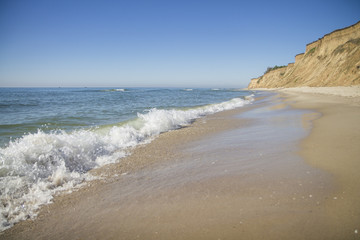 The deserted fairy tale beach with golden sand, beautiful sky and turquoise water on the shores of ocean.