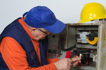 electrician fixing  electrical system with different tools