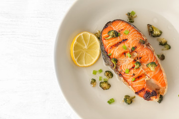 Plate of tasty fish with sauce on table