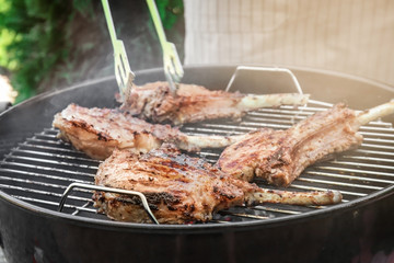 Cooking of appetizing juicy spare ribs outdoors