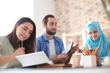 Muslim student with classmates in library