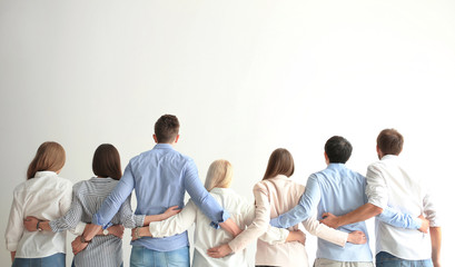 People holding hands on light background. Unity concept - obrazy, fototapety, plakaty
