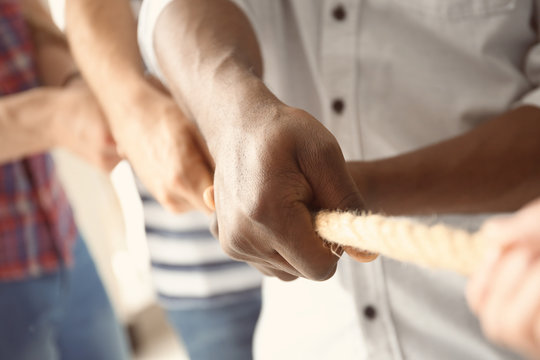 People Pulling Rope Together, Closeup Of Hands. Unity Concept