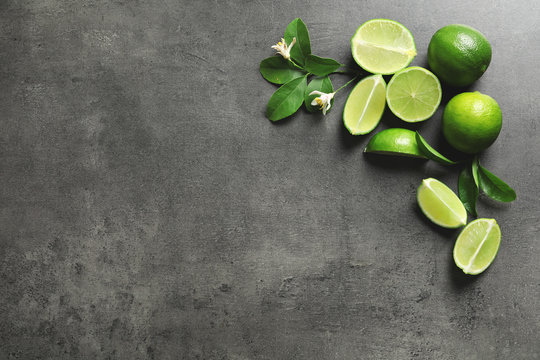 Composition with fresh ripe limes on gray background, top view