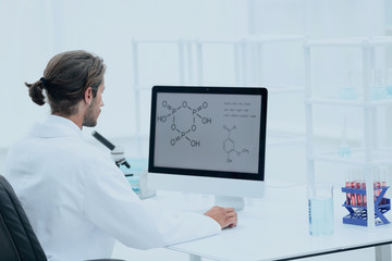 research scientist using computer chemistry laboratory