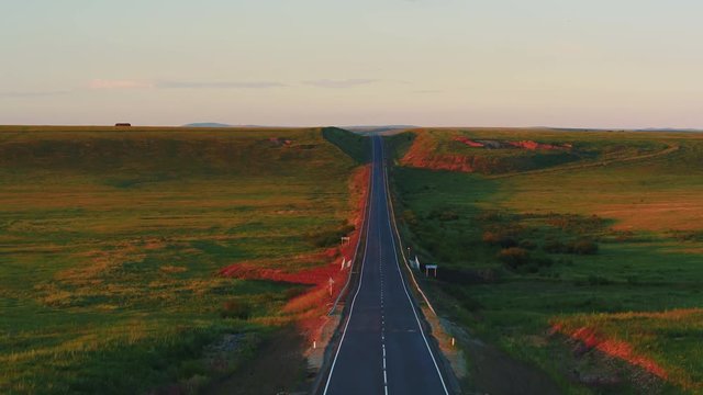 Aerial view of empty paved road in rural fields. backward follow drone video 4k