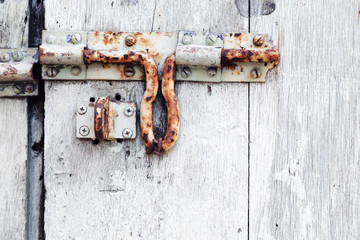 old rusty vintage padlock on grunge wooden door