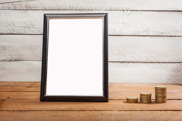 Mockup image photo frame with copy space and cash coins on desk