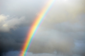 a bright rainbow on a dark stormy sky.