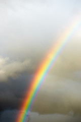 a bright rainbow on a dark stormy sky.