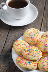 Cookies with colored sprinkles and coffee