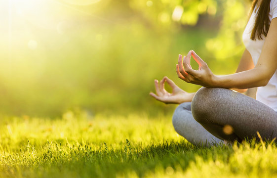 Yoga woman meditating at sunset. Female model meditating in serene harmony