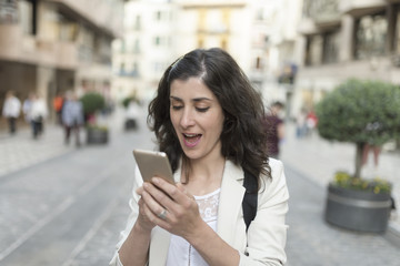 woman looking smartphone in the city