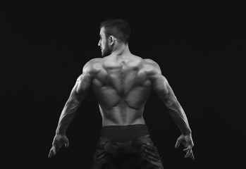 Obraz na płótnie Canvas Unrecognizable man shows strong back muscles closeup