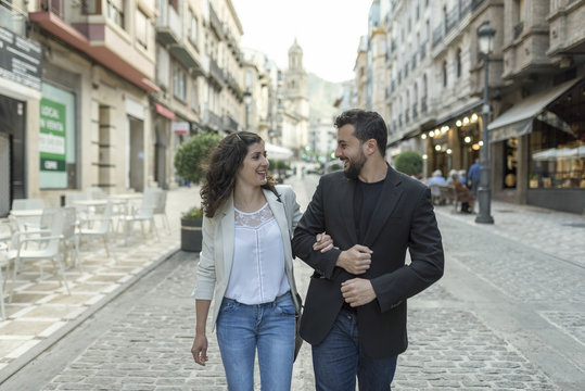 Couple walking and having fun walking in the street together