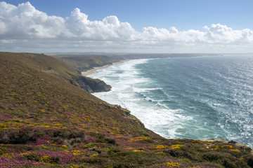 View along the St Agnes Heritage Coast towards Chapel Porth Beach on a sunny summer afternoon in Cornwall, UK