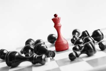White chess queen beats blacks on chessboard