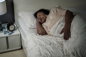 Fototapeta na wymiar senior woman sleeping in a bed