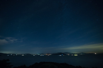 Fototapeta na wymiar 星空と瀬戸内海の夜景(香川県小豆島近辺)