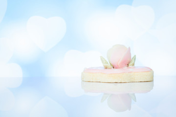 Biscuit top with sugar rose flower on blurry background