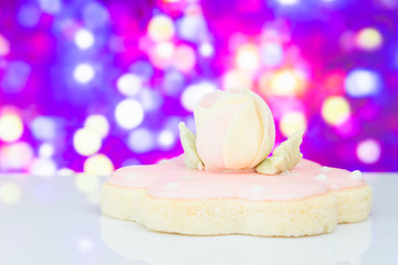 Biscuit top with sugar rose flower on blurry background