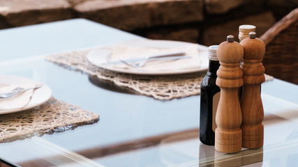 Salt and pepper on a table in a restaurant