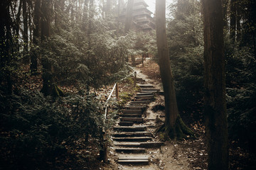 Nature stairs path in the mountains, stone stairway for hiking leading to christian church in...