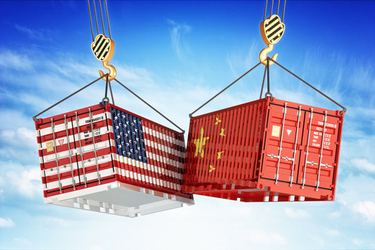 Economic trade war between USA and China, freight transportation concept, cargo containers with USA and China flags hoisted by crane hooks on blue cloudy sky background