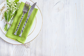 Festive table setting with bouquet of lilies of the valley © stsvirkun