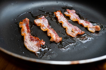 slices of fresh fried bacon in a pan