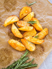 Oven roasted potatoes with rosemary herb , top view, healthy baked potatoes seasoned with rosemary herb