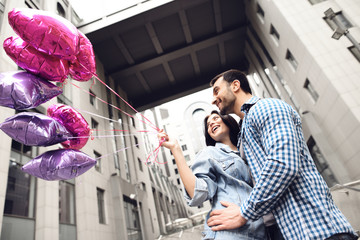 Happy young couple walking around the city.