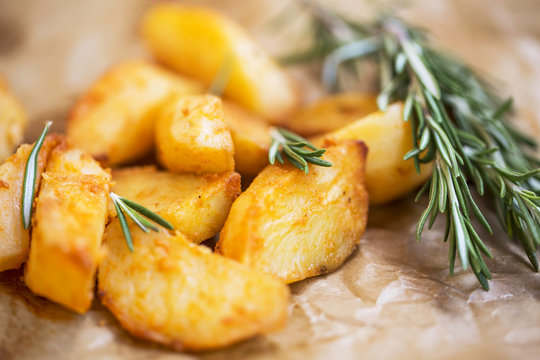 Oven roasted potatoes with rosemary herb , selective focus