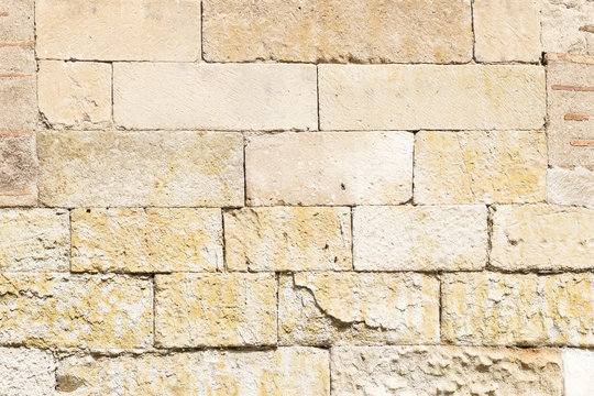 Old stone wall Orange worn by the passage of time, to wallpaper
