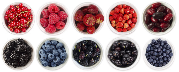 Black-blue and red berries isolated on white background. Collage of different fruits and berries. Collage of different fruits and berries in a bowl. Top view. 