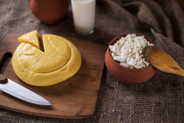 Organic milk cottage cheese and sour cream in vintage dish on rustic background