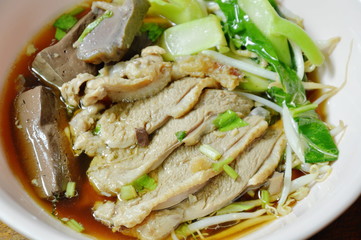 boiled duck meat and blood in brown Chinese herb soup on bowl