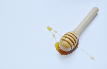 wooden honey scoop on white background